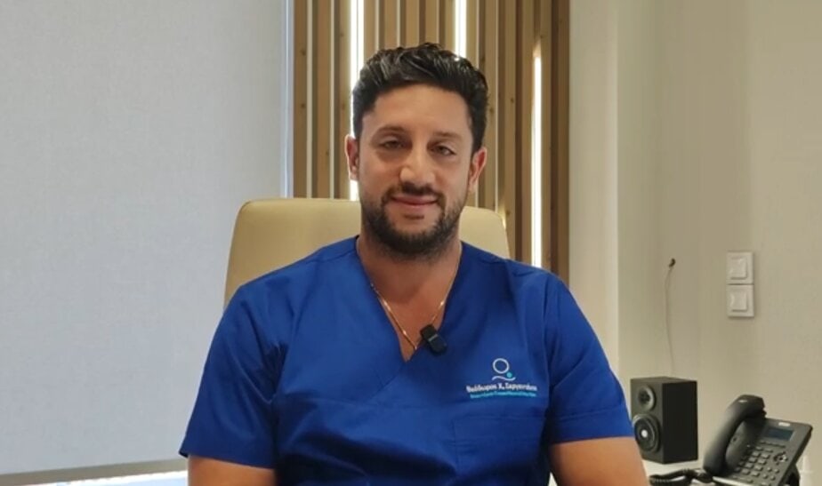 Emergency medical professional in blue scrubs at eKorinthos hospital in Corinth Greece.